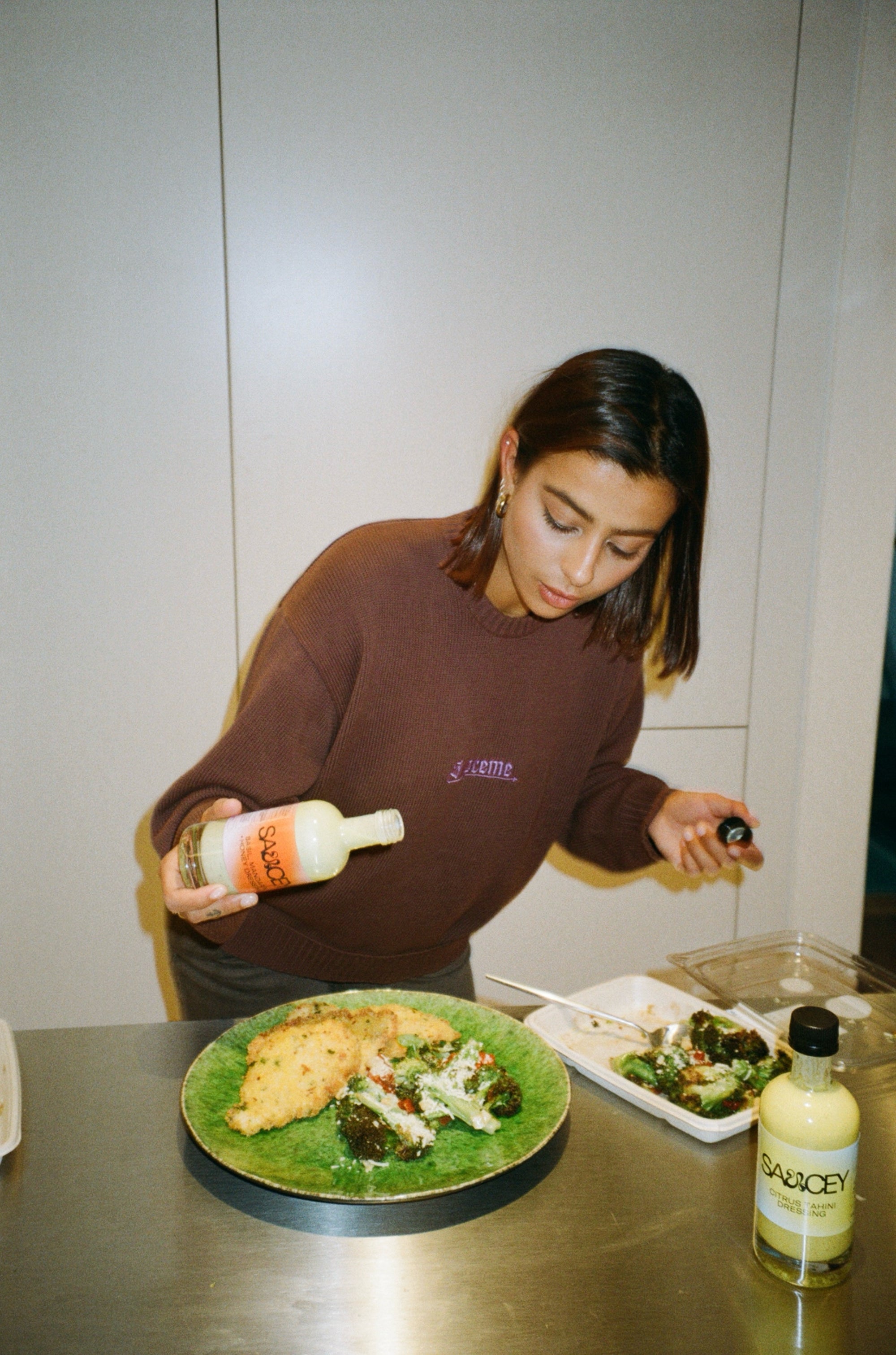 A girl pouring honey dressing